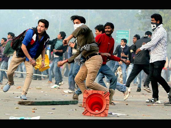 Protesters pelt stones towards police Protesters pelt stones towards police