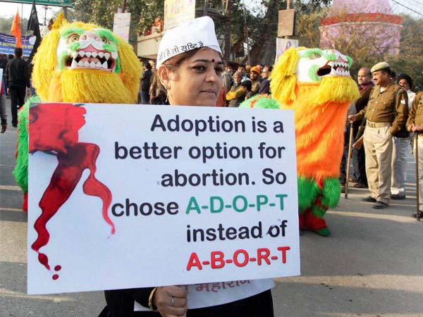 A woman displays a placard A woman displays a placard