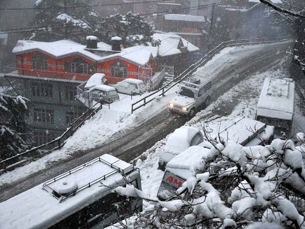 Vehicles plying on a snow-covered road