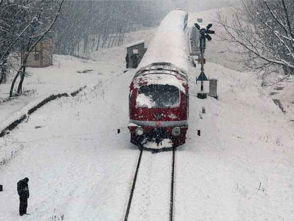 The snow envelops a moving train