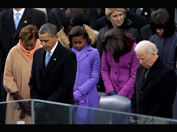 Barack Obama and Vice President Joe Biden listen to the benediction