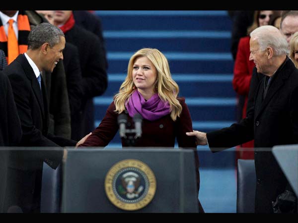 Singer Kelly Clarkson is greeted by President Barack Obama