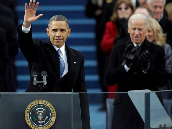 Barack Obama waves after his speech while Joe Biden applauds