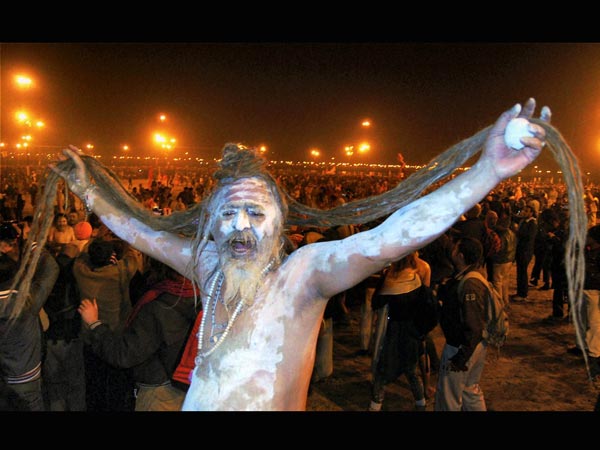  A Sadhu displays his hair before taking a predawn holy dip
