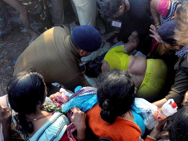 A police officer and people try to rescue a woman