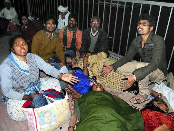 People mourn the death of their relatives in stampede