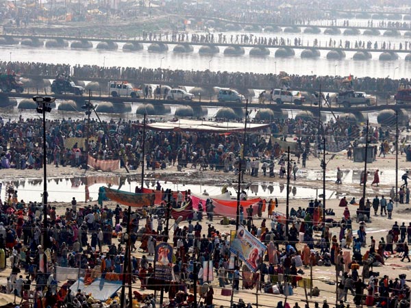 Thousands of devotees walk across a pontoon bridge