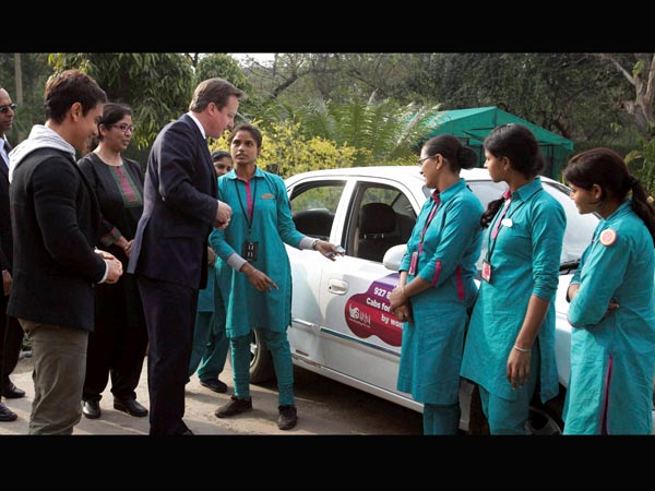 David Cameron and actor Aamir Khan with women cab drivers