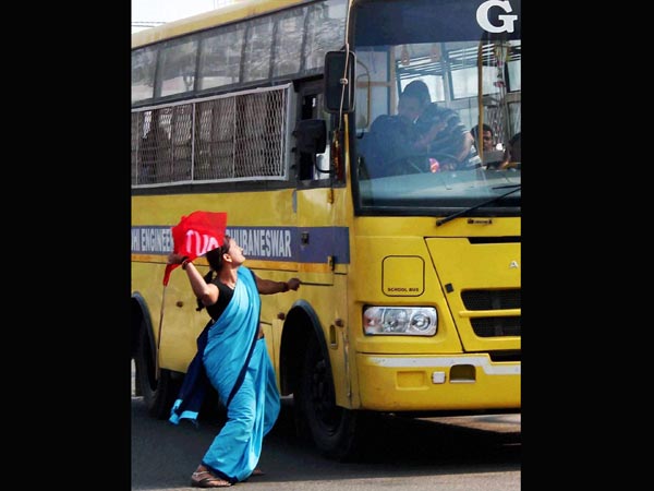 An activist try to stop a vehicle