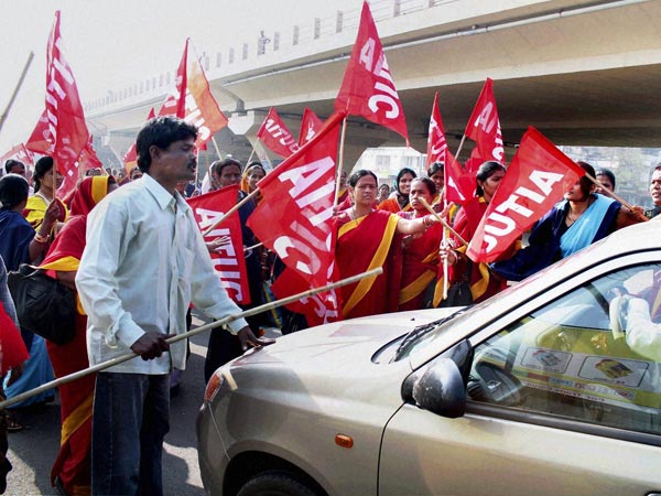 Activists try to stop a vehicle on the day of 'Bharat Bandh'