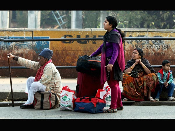 Passengers wait for Transport with their luggage