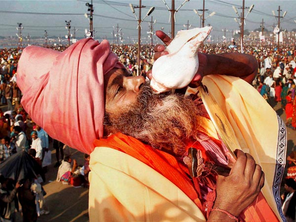 A Sadhu blows 'conch' 