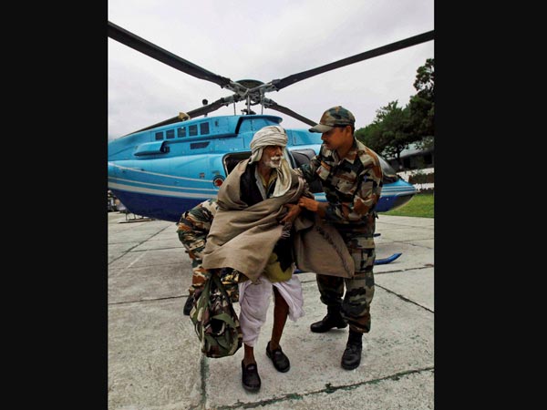 An army soldier comforts an injured pilgrim