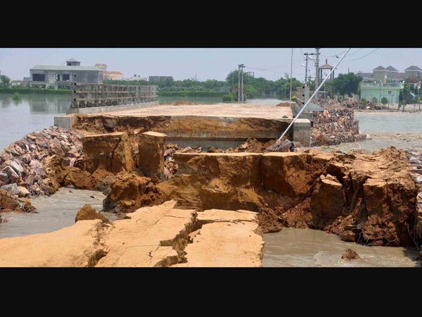 A damaged bridge in flooded Manjhawli