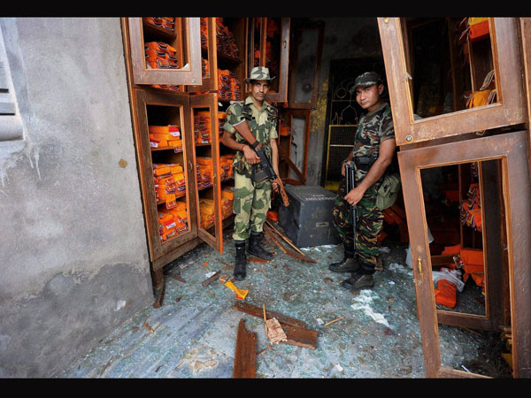 Security personnel inspect the site of blast