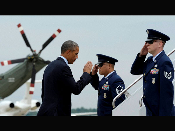 Barack Obama returns a salute