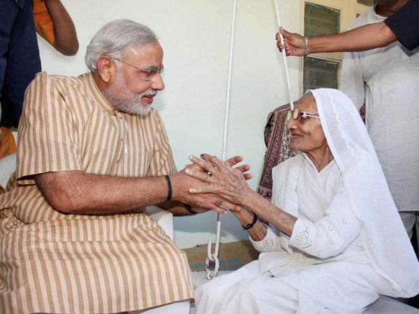  Narendra Modi meets mother on 64th birthday, thanks supporters