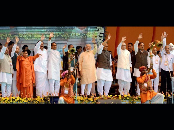 BJP leaders wave during the mega rally in Bhopal