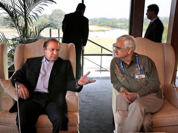 Pakistani Prime Minister Nawaz Sharif, left, talks with Indian Foreign Minister Salman Khurshid