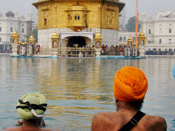 Sikh devotees take bath in the holy sarovar