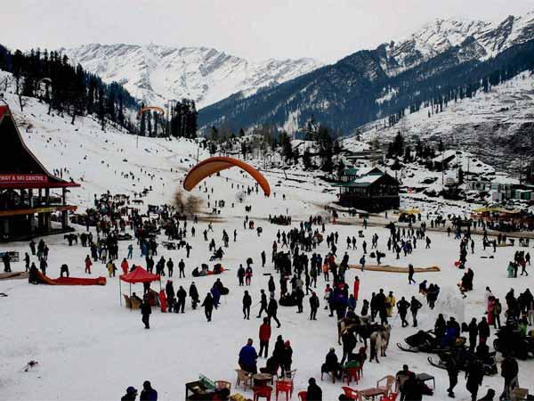 Tourists enjoy the snowfall