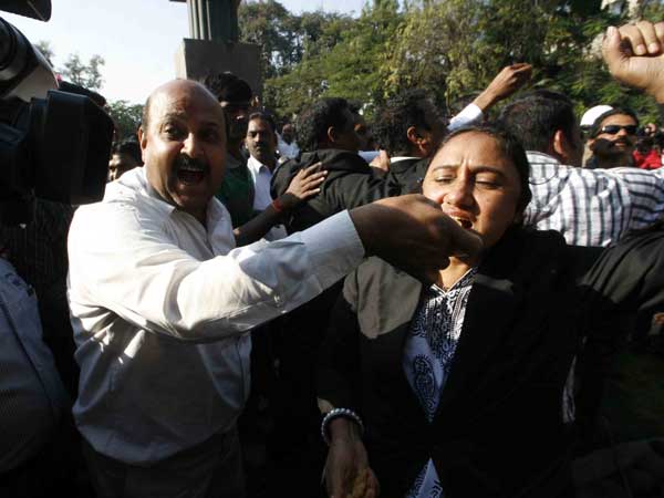 People distribute sweets after the passing of Telangana Bill