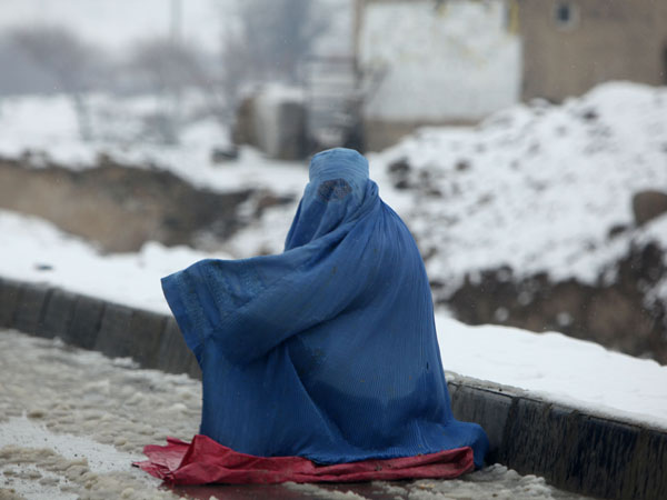 She braves cold weather for alms