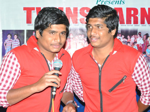 Twin brothers perform on stage Twin brothers perform on stage