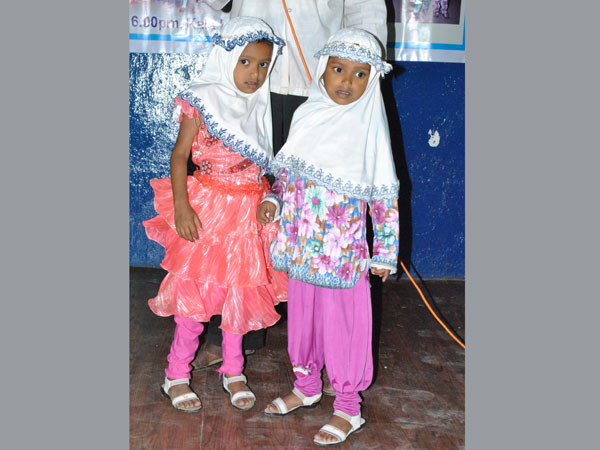 Little twin sisters perform on stage Little twin sisters perform on stage