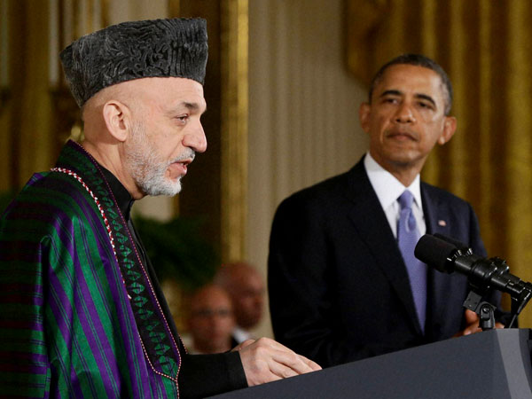 President Barack Obama listening to Afghan President Hamid Karzai