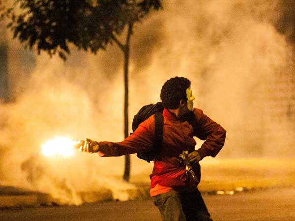 A student throws a burning object