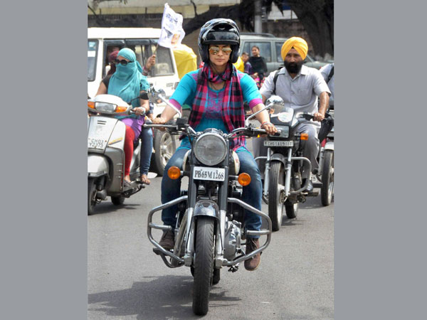 Aam Aadmi Party candidate Gul Panag riding a bike