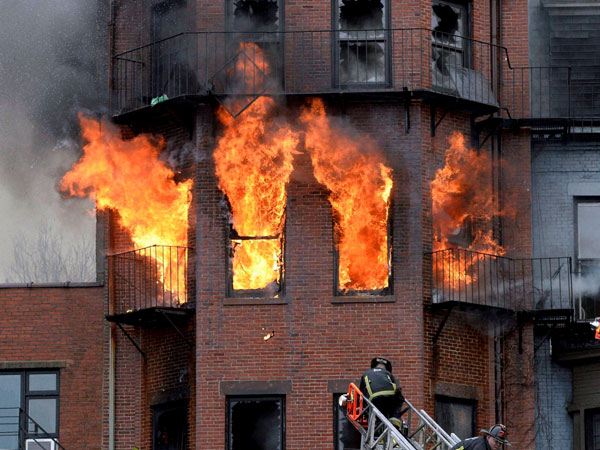 Boston firefighters work a multi-alarm brownstone fire