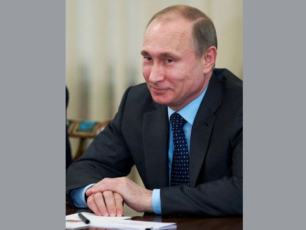 Russian President Vladimir Putin smiles