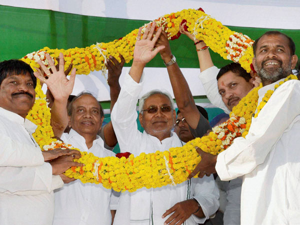 Nitish Kumar being garlanded by supporters at election meeting