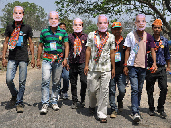  BJP supporters wear masks of party's PM candidate Narendra Modi