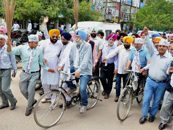 H S Phoolka along with party members rides a bicycle
