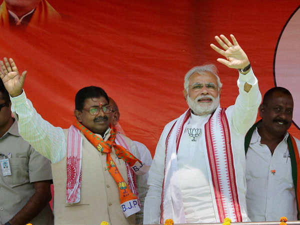 Narendra Modi waves to supporters during an election campaign