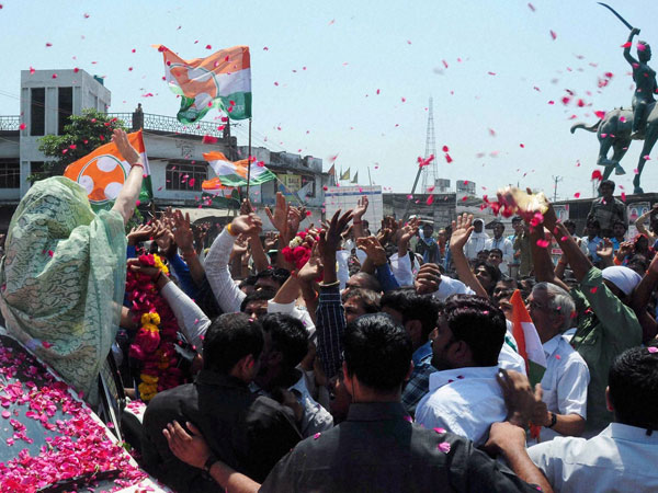 Sonia Gandhi waves to supporters during her nomination