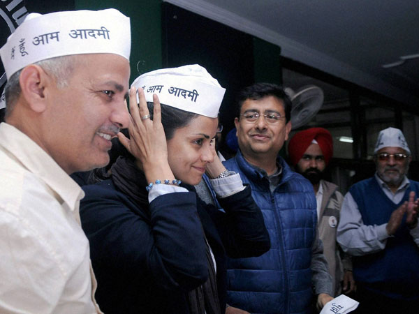 AAP leader Manish Sisodia looks on as actress Gul Panag
