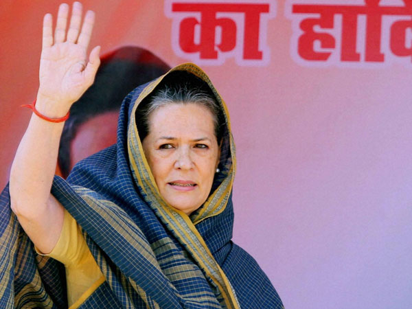 Sonia Gandhi waves to supporters during an election campaign