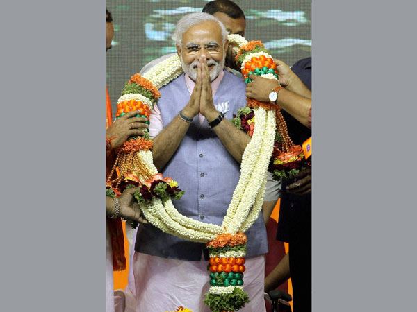 Narendra Modi wears a garland during a Bharat Vijay rally