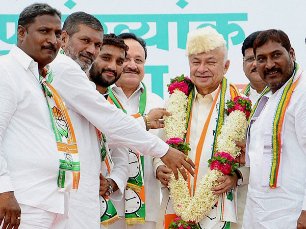 Sushil Kumar Shinde being garlanded at his election campaign