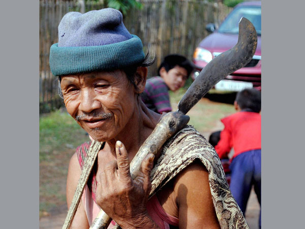 An old person shoing his mark after casting his vote