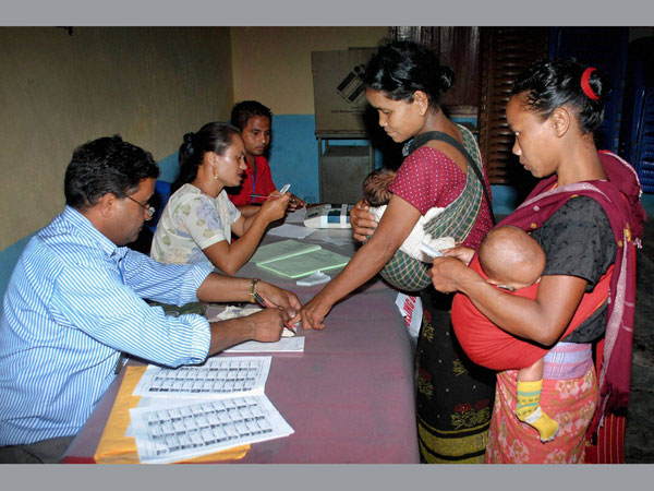 People get their ink mark as they queue to cast their vote