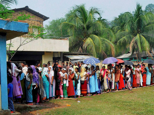 Voters stand in queues to cast their votes