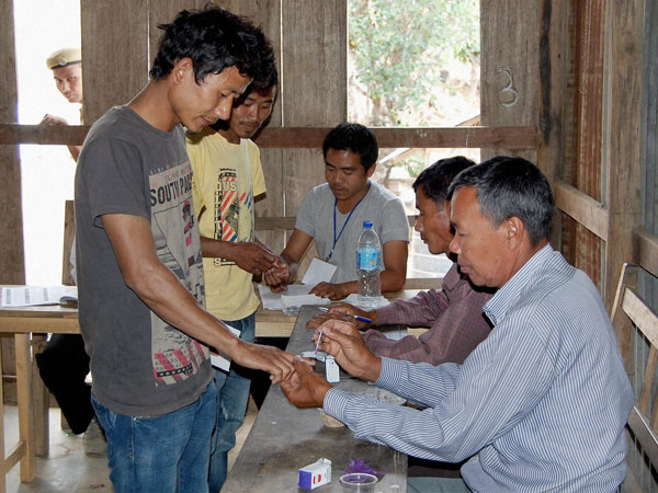 A young voter gets his finger marked