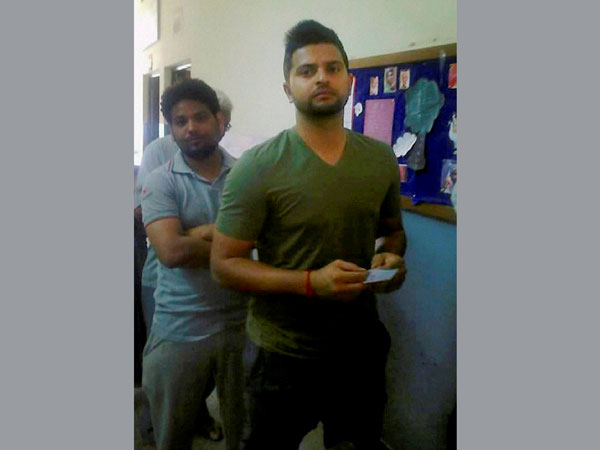 Suresh Raina in queue to cast his vote Suresh Raina in queue to cast his vote