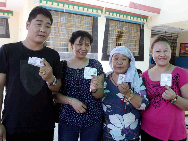 Tibetans show their voter ID card Tibetans show their voter ID card