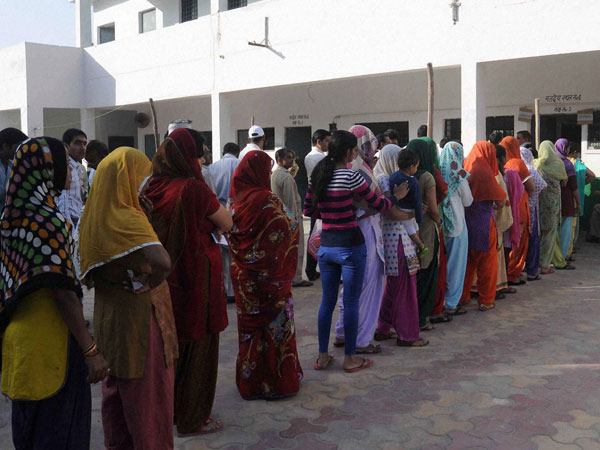 Voters stand in queue to cast their votes Voters stand in queue to cast their votes
